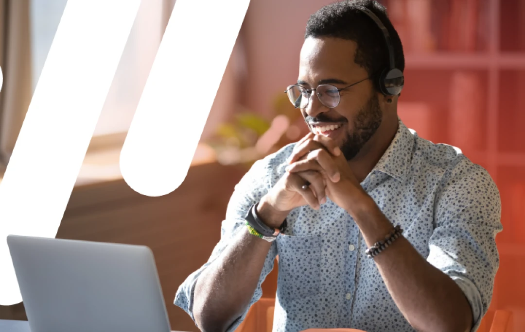 man smiling at laptop