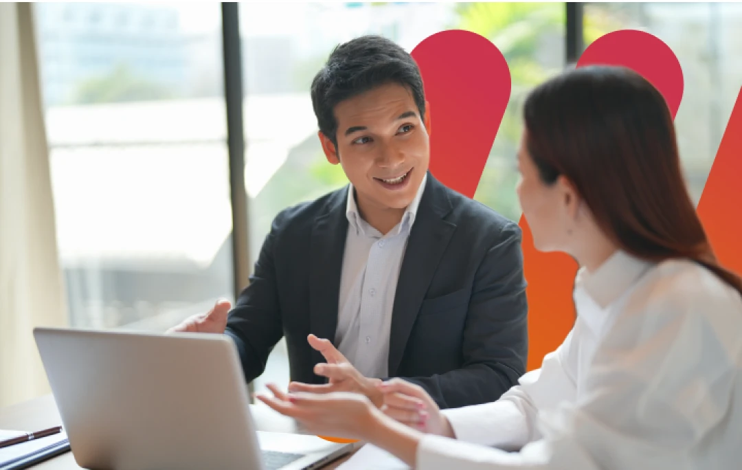 co-workers smiling at laptop