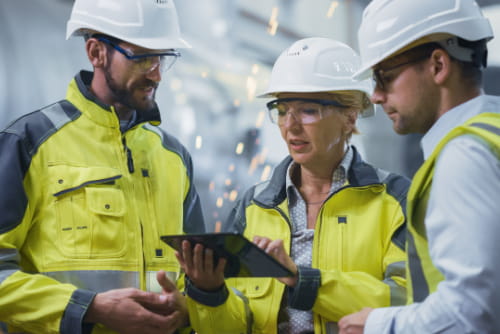 Engineers looking around a tablet