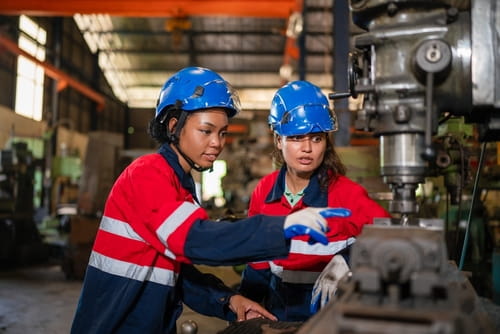 Mechanical engineers inspecting a machine